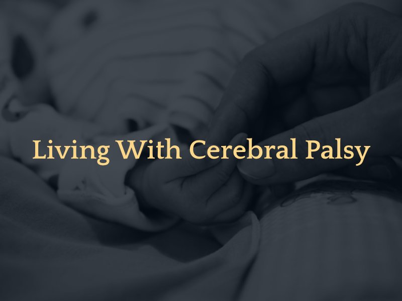 mother holding newborn's hand with text caption: living with cerebral palsy 